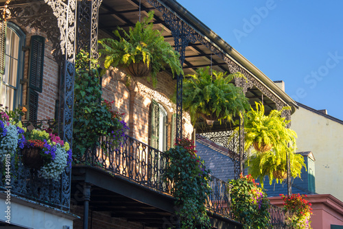 US, LA, New Orleans French Quarter. Lush balcony gardens, Morning light makes patterns through ironwork