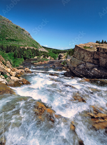 USA, Montana, Glacier NP. Swiftcurrent Falls tumbles into Lake Sherburne from the Many Glaciers area of Glacier National Park, Montana. photo