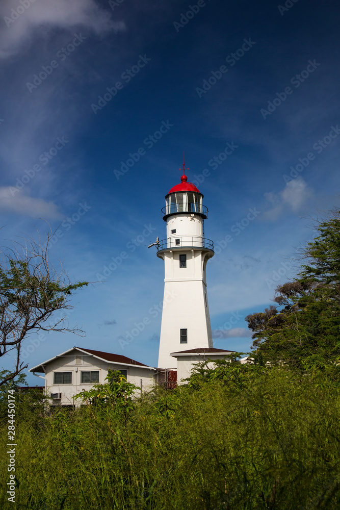 USA, Hawaii, Oahu, Morning light on Diamond Head Lighthouse with Puffy Clouds