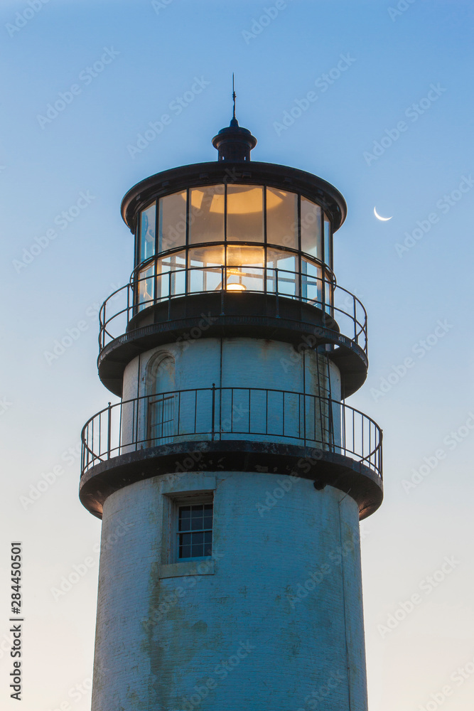 A crescent moon and the Cape Cod Lighthouse, a.k.a. Highland Light, in Truro, Massachusetts. Cape Cod National Seashore.