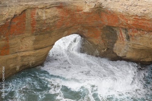 USA, Oregon. Ocean wave pushes through rock formation. 