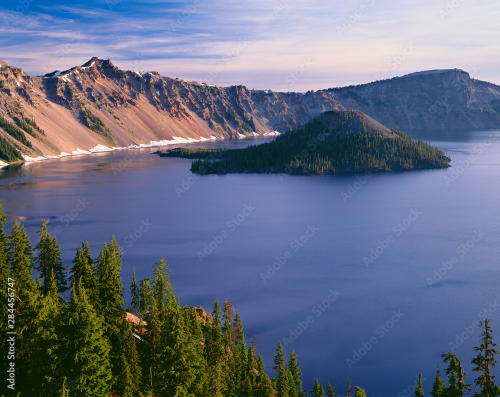 USA, Oregon, Crater Lake National Park. West rim of Crater Lake with Hillman Peak (center) and Llao Rock (right) above Wizard Island.