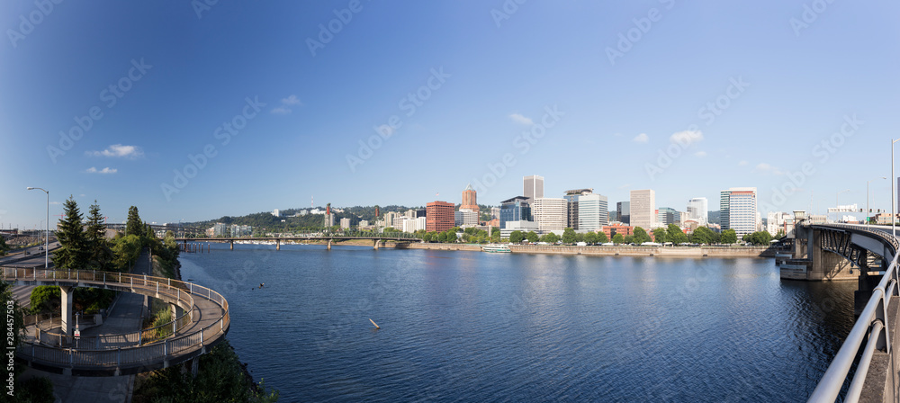 USA, Oregon, Portland. Downtown from across the Willamette River with a pedestrian walkway. Panoramic