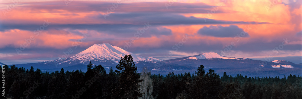 USA, Oregon, Mt Bachelor. Clouds take on sunrise colors above Mt Bachelor in the Cascades Range near Bend, Oregon.