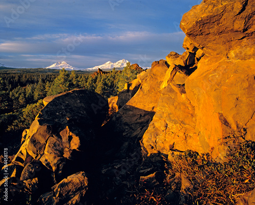 USA, Oregon, Three Sisters. A rock outcrop catches first light near the Three...