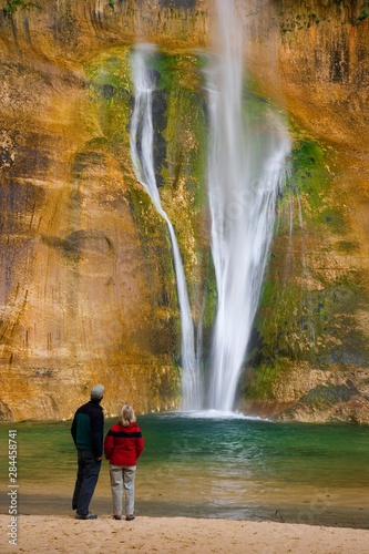 USA  Utah. Man and woman view Calf Creek Falls. 