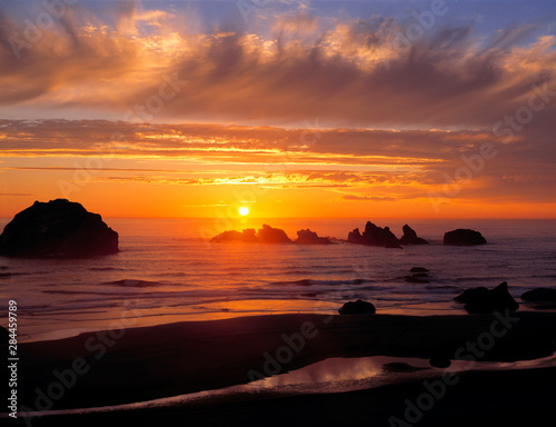 USA, Oregon, Face Rock Wayside. A wildly-colored sunset graces the sky at Face Rock Wayside on the Oregon Coast.