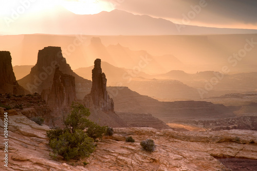 USA; Utah; Canyonlands National Park. View of Washer Woman and Mesa Arch at sunrise. 