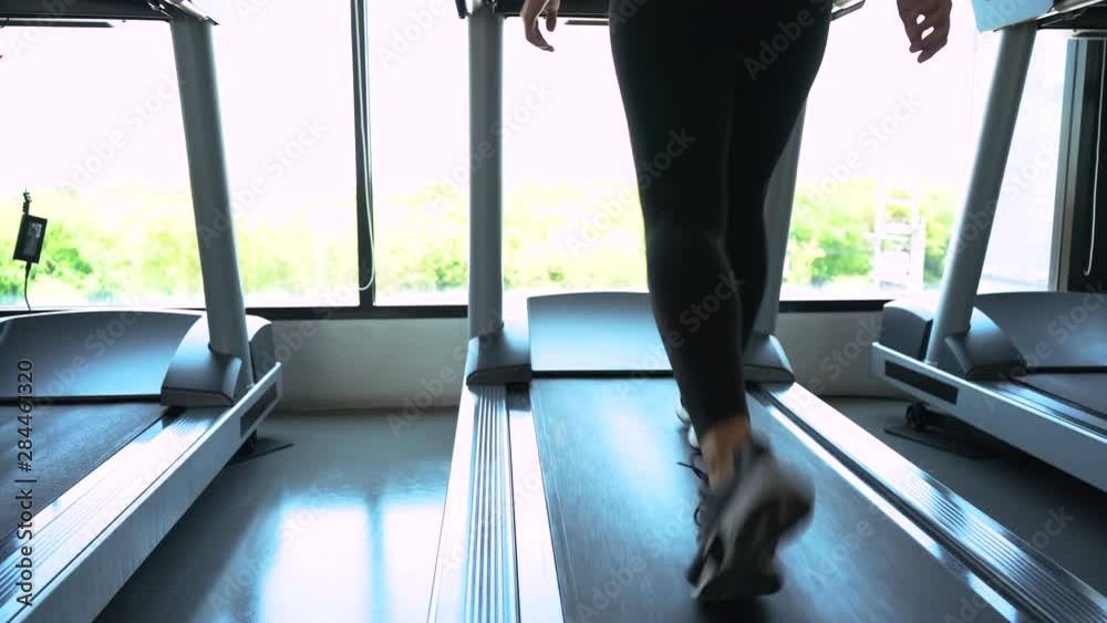 Exercise treadmill cardio running workout at fitness gym of woman taking weight loss with machine aerobic, 4k resolution Exercise treadmill cardio running workout at fitness gym of woman taking weight loss with machine aerobic, 4k resolution