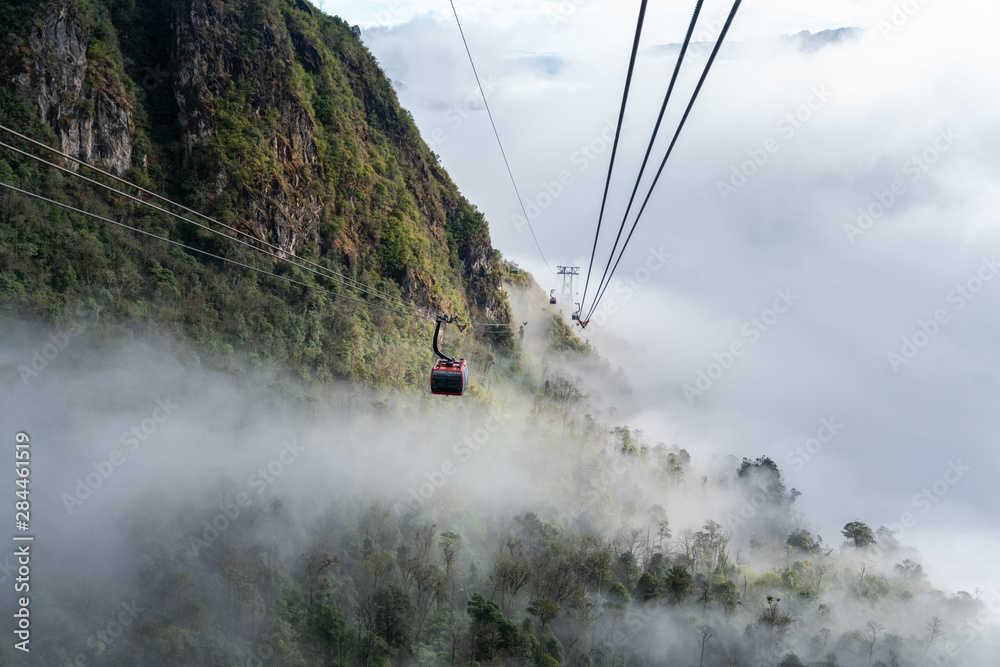 The cable car to mountain top with low clouds and mountain view The cable car to mountain top with low clouds and mountain view