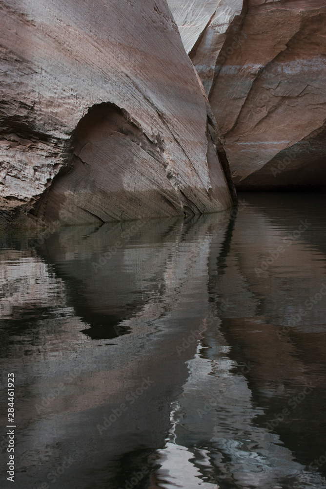 Usa, Utah, Glen Canyon National Recreation Area. Rock formations near Cathedral in the Desert with canyon wall reflections emerged from the lowering water level of Lake Powell. Usa, Utah, Glen Canyon National Recreation Area. Rock formations near Cathedral in the Desert with canyon wall reflections emerged from the lowering water level of Lake Powell.