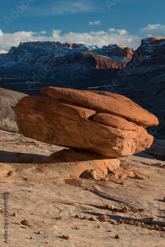 USA, Utah. Mushroom red rock formation overlooking snow covered cliffs, valley and Colorado River