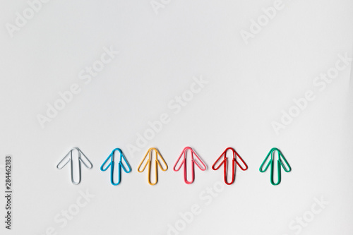 Many arrows on white background, shot from above, aligned at the bottom.