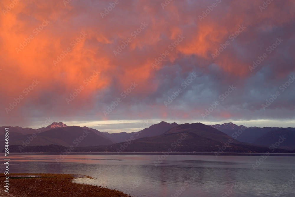 USA, Washington, Seabeck. Sunset creates orange clouds over Hood Canal and Olympic Mountains. 