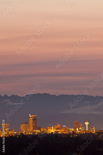 USA, Washington State, Seattle, downtown skyline with Space Needle and Olympic Mountains at sunset.