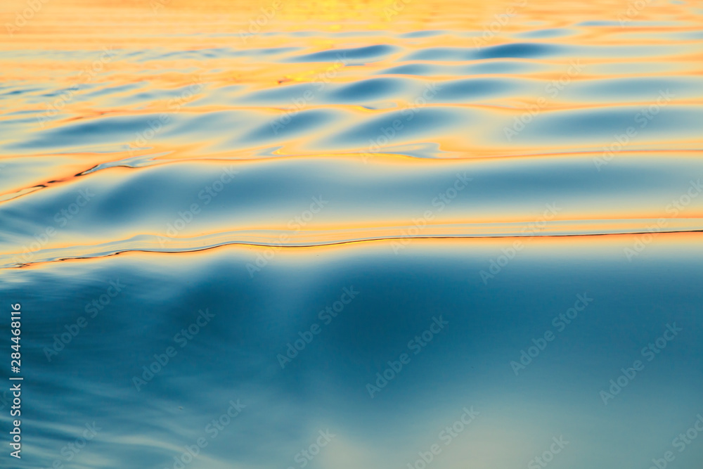 Sunset reflecting on smooth surface and small ripples, Moses Lake, Washington State, USA