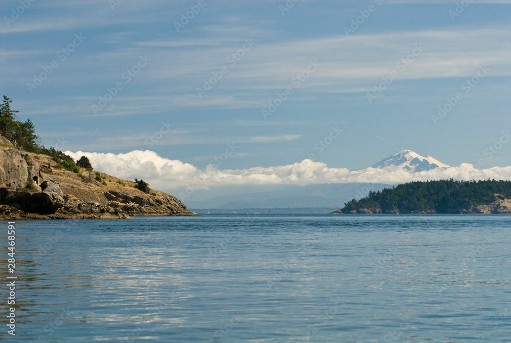 USA; WA; San Juan Islands; Majestic Mt Baker stands above clouds. View from Sucia Island