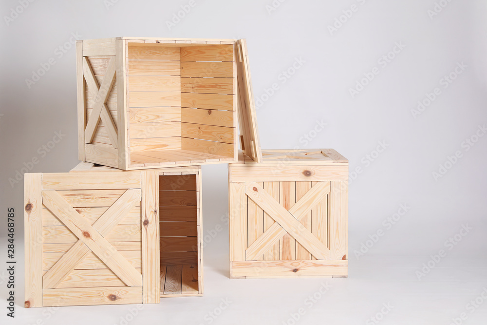 Wooden crates on grey background. Space for text Wooden crates on grey background. Space for text