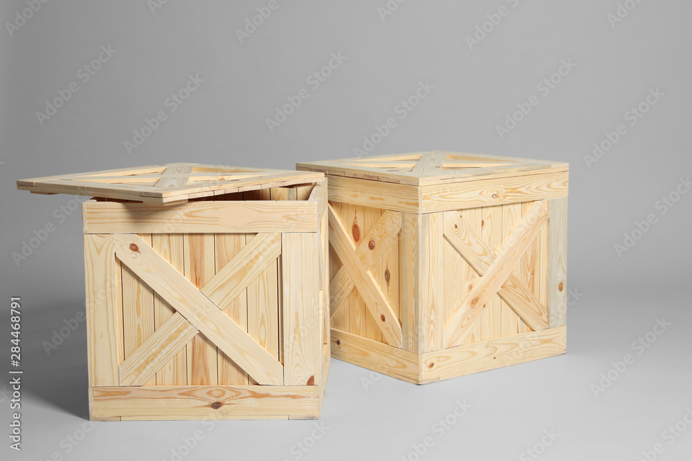 Pair of wooden crates on grey background Pair of wooden crates on grey background
