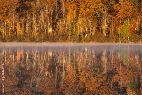 USA, Wisconsin. A cold morning on a Mill pond Lake in Autumn.