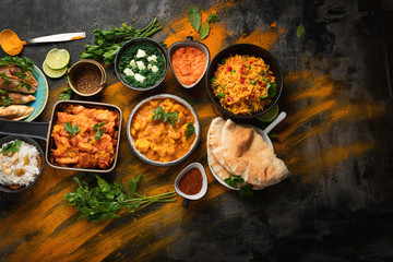 Assorted indian food on black background..