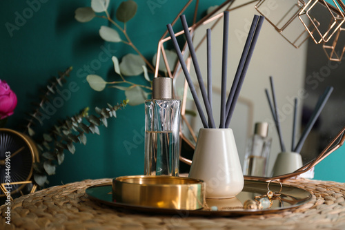Composition with stylish accessories and interior elements on table near turquoise wall