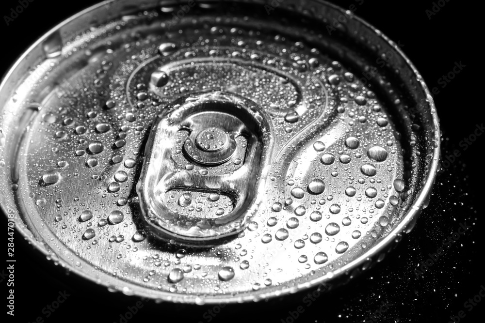 Aluminum can of beverage covered with water drops on black background, closeup Aluminum can of beverage covered with water drops on black background, closeup