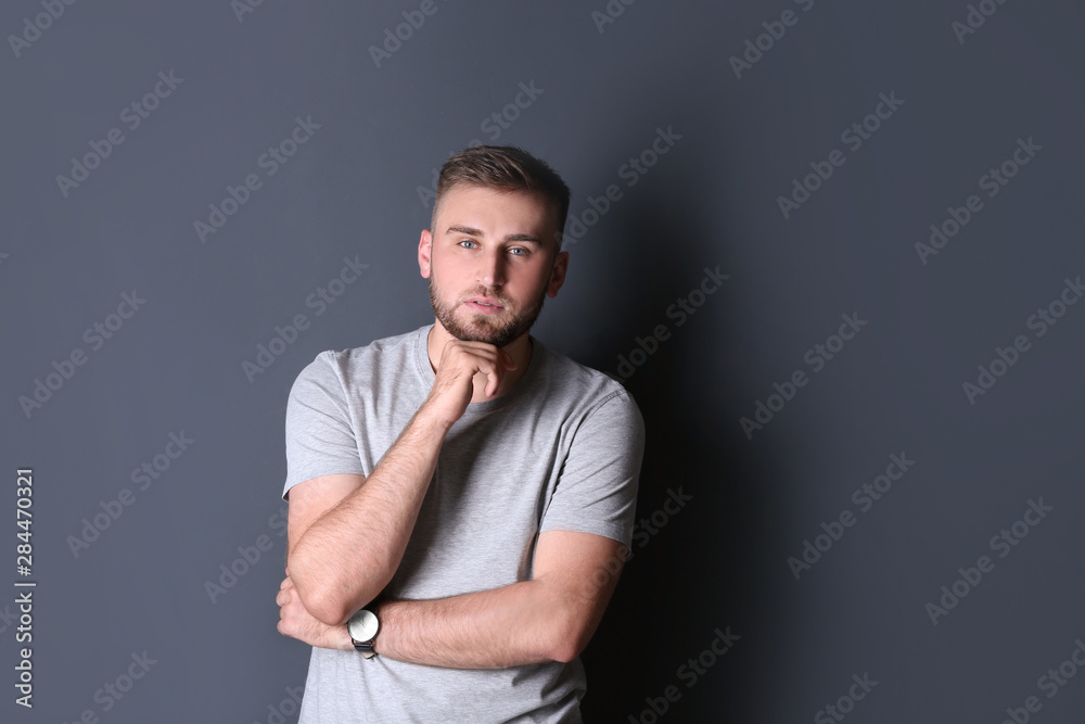 Portrait of handsome serious man on grey background. Space for text