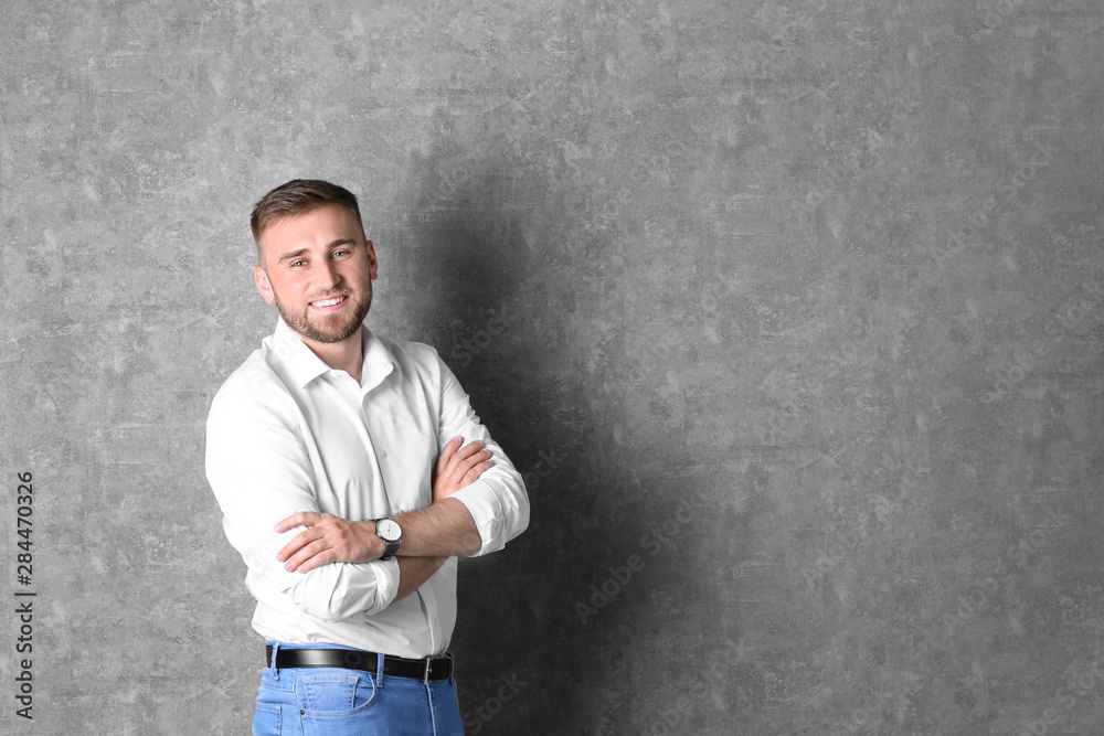 Portrait of handsome happy man on grey background, space for text Portrait of handsome happy man on grey background, space for text