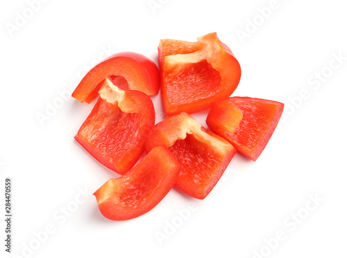 Slices of ripe red bell pepper on white background