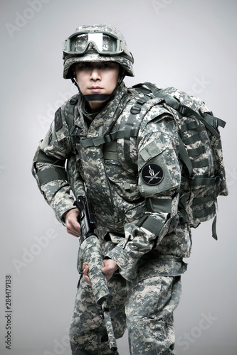Obraz na płótnie Armed soldier holding a rifle. w salonie