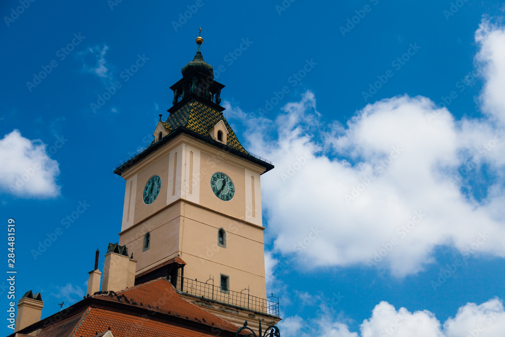 The old Town Square of Brasov (Piata Sfatului). The famous City Hall building with the clock tower seen in the background.