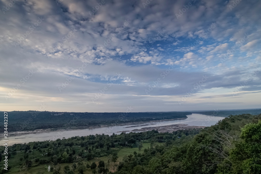 Mountain view morning of Mekong river around with green forest and cloudy sky background, Pha Taem National Park, Ubon Ratchathani, Thailand.