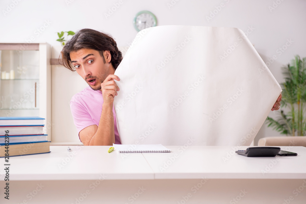 Young male architect student preparing for exams at home Young male architect student preparing for exams at home