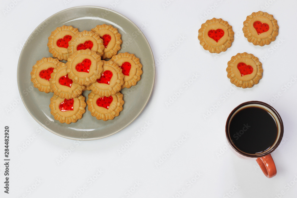 Valentines day heart shaped red jam filled cookies on plate isolated on white .top view.space for text and copy Valentines day heart shaped red jam filled cookies on plate isolated on white .top view.space for text and copy