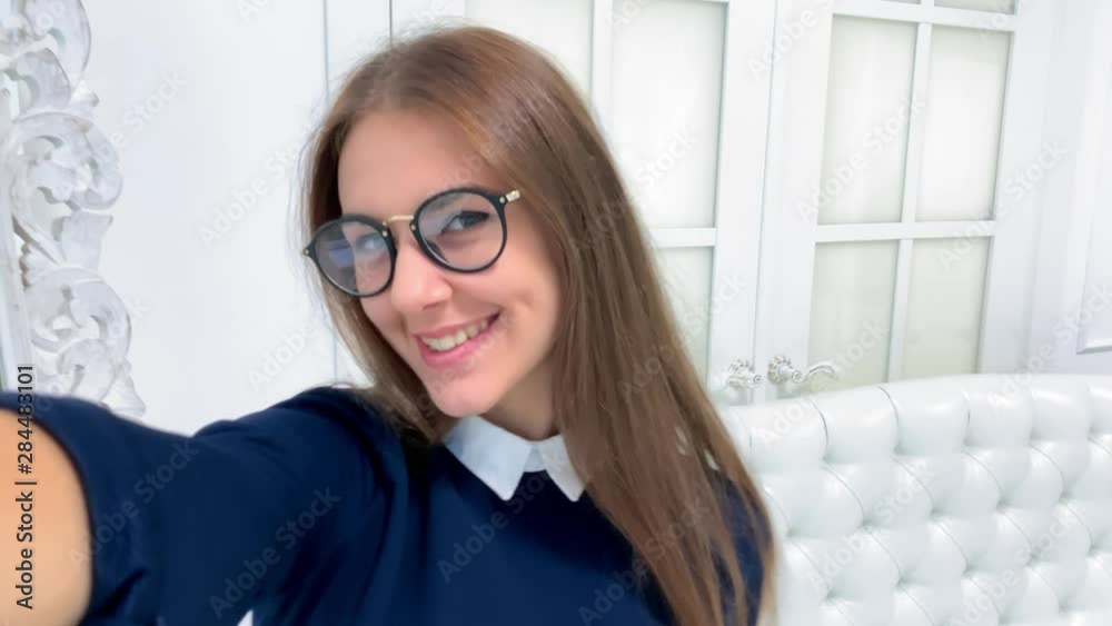 Beautiful girl having video chat using smartphone the background of the mirror sends air kiss, smiles and laughs, girl filming selfie video photo for social media Beautiful girl having video chat using smartphone the background of the mirror sends air kiss, smiles and laughs, girl filming selfie video photo for social media