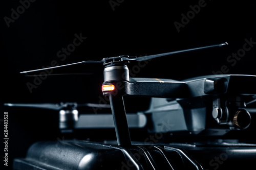 DJI Mavic 2 - Flying in the dark, on black background. Closeup on black background.