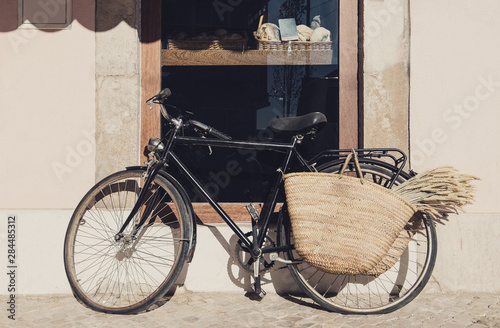 Old bicycle with a basket on a city street