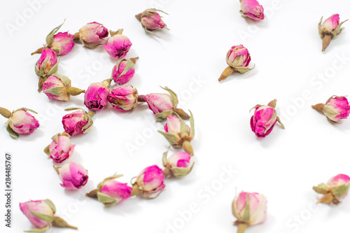 Greeting Card International Women's Day on March 8th. Dry pink roses in the form of number eight.