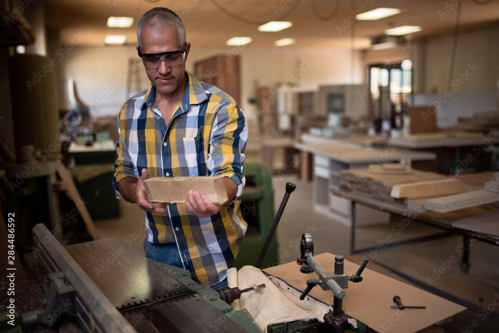 the master uses a woodworking machine