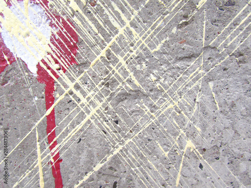  Colored stripes and stains of paint on a rough concrete wall. Leaked paint. Grunge geometrical pattern. 