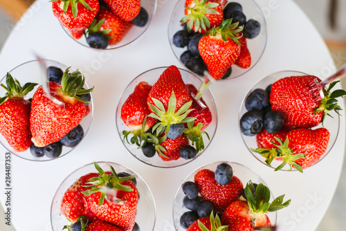 strawberries and blue berries on an elegant setting 