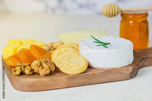 cheese plate camembert cheese  rosemary  crackers dry apricot and walnuts
