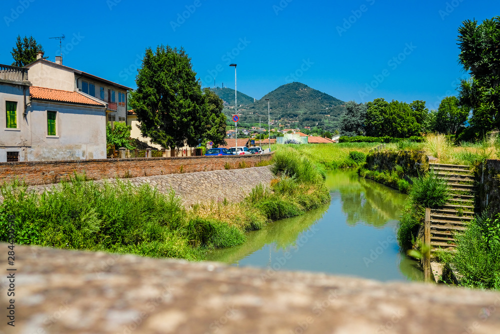 Este, Italy - July, 27, 2019: Landscape with the image of channel in Este, Italy