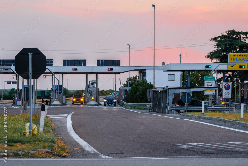 Rovigo, Italy - July, 26, 2019: highway toll station in Italy at sunset Rovigo, Italy - July, 26, 2019: highway toll station in Italy at sunset