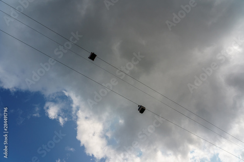 cabins and cables of a cableway against the sky