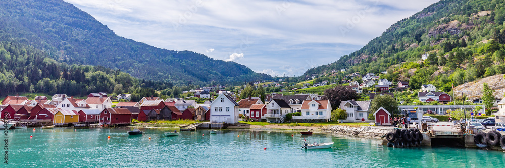 View at Solvorn, a picturesque little village with white wooden houses along Lustrafjorden on a summer day in Sogn og Fjordane county in Norway.