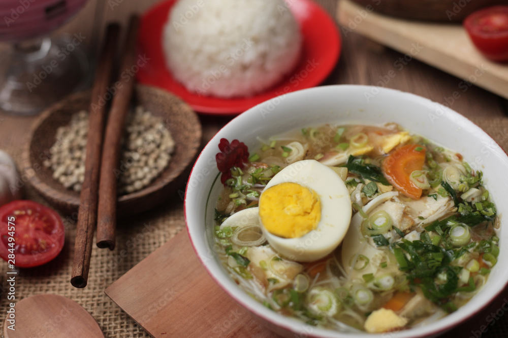 Indonesian chicken soto or soto ayam, served with white rice Indonesian chicken soto or soto ayam, served with white rice