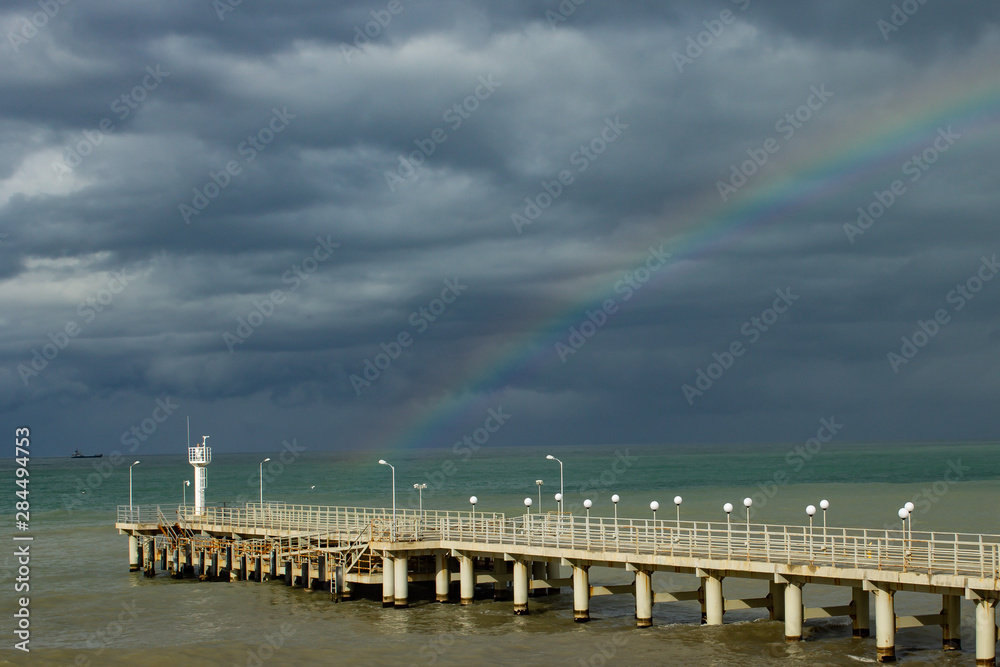 Sea, pier, clouds, the weather is changing.