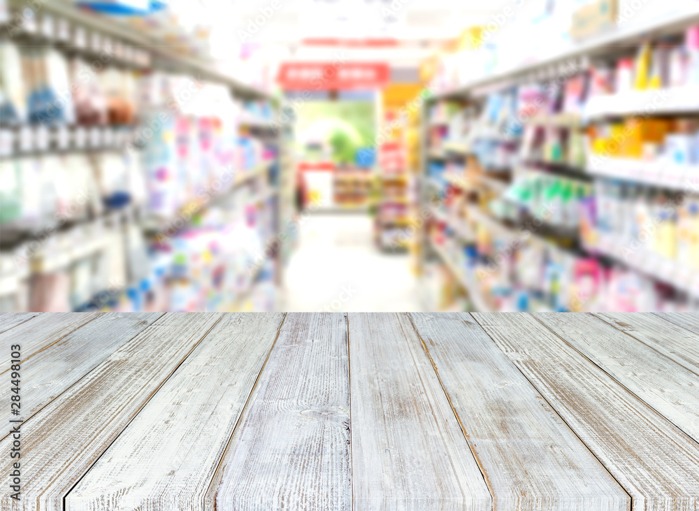 Perspective wood table on blurred abstract interior of super market department store that provides a surface for the storage or display of your products